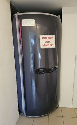 a water heater in the corner of a room with a sign on it