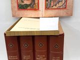 three books are stacked on top of each other on a white surface