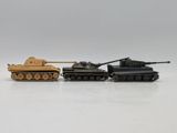 two toy tanks are sitting side by side on a white surface