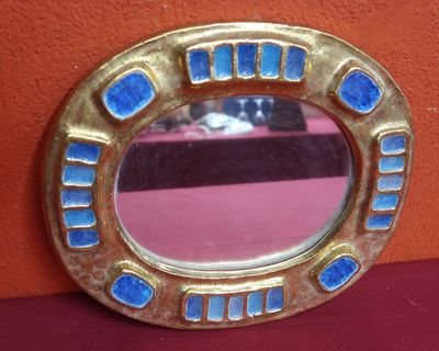 a mirror that is sitting on a red table