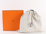 an orange box and a white bag with a logo on it