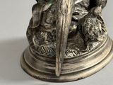 silver plated figurine of a parrot perched on a tree branch