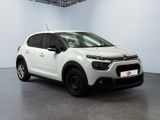 a white citrole is parked in a large room