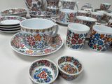 many different types of cups and saucers on the table
