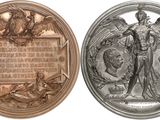 four different types of silver and bronze medals on a white background