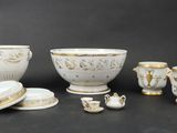 a group of white and gold items on a black surface