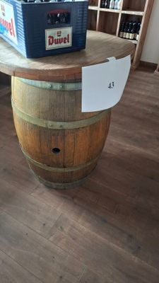 a wooden barrel with a cooler on top of it
