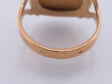 a close up of a gold ring with a diamond on it