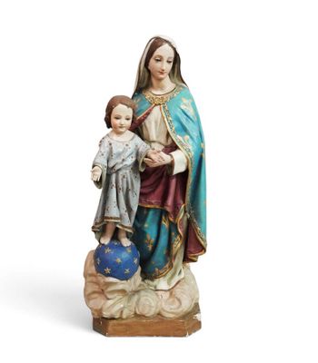 the statue of the virgin and child is standing on a rock