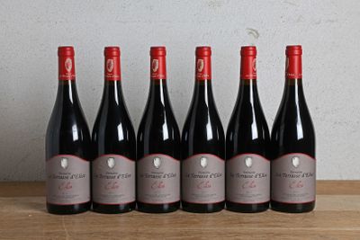 six bottles of red wine lined up on a wooden table