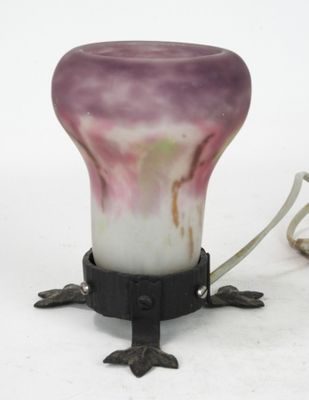 a purple and white vase sitting on top of a table