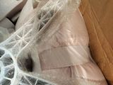 a cardboard box filled with a pair of white shoes