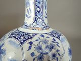 a blue and white vase sitting on a table