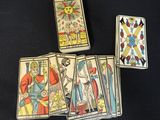 a group of four tarot cards sitting on top of a table