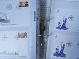 four envelopes with stamps and a pen on top of them