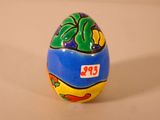 a painted egg on a table with a price tag on it