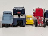many toy trucks lined up in a row on a table