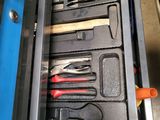 a tool drawer with tools in it and a pair of scissors in the drawer