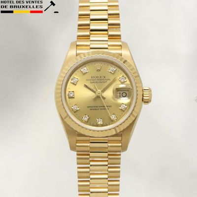 an image of a gold rolex watch with diamonds on the dial