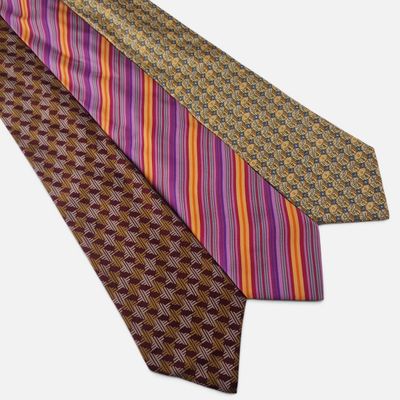 three ties with different colors and patterns on them on a white background