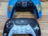 two video game controllers sitting on a wooden table