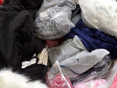 a pile of clothes in a bag on the floor