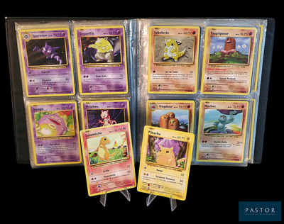 a lot of pokemon cards that are in a case