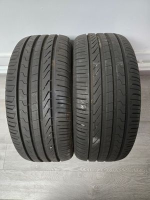 a pair of tires on a wooden floor next to a wall