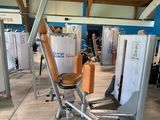 a gym room with a row of machines in it