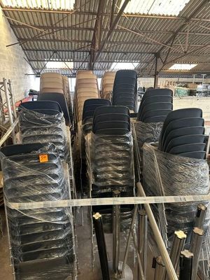 a lot of chairs that are wrapped up in plastic