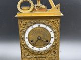 a gold clock that is sitting on a table