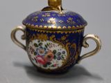 an image of a blue and gold bowl with flowers on it