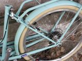 a blue bicycle parked on the side of the street