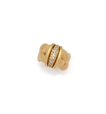a yellow gold ring with diamonds on a white background