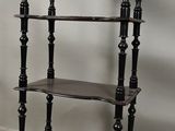a black shelf with a clock on top of it