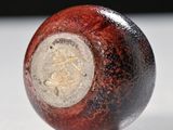 a close up of a red ball on a white surface