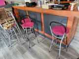 three bar stools in front of a counter in a coffee shop
