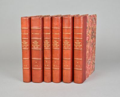 six livres rouges alignés les uns à côté des autres sur une surface grise