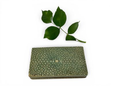 a small green wallet with a leaf on top of it