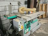 a machine that is sitting on a table in front of a brick wall