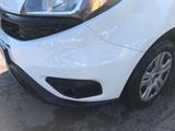 a white car parked in a parking lot with other cars