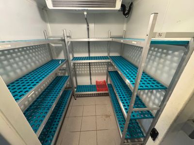 a small room with a lot of shelves in it