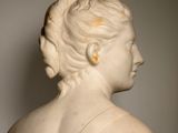 marble bust of a woman in profile with her hair in a bunt