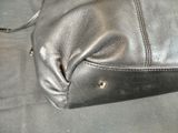 a black purse that is sitting on a table