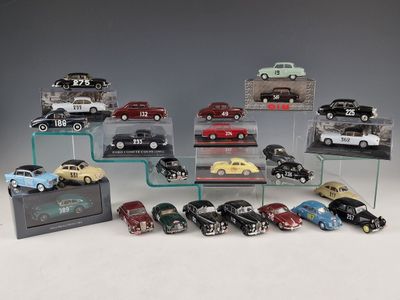 a lot of toy cars on display on a glass shelf