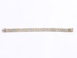 a silver and gold bracelet on a white background