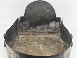 a metal tray with a metal lid and a knife