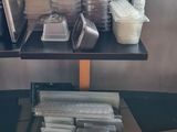 many containers of food sitting on a table near a window