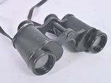 a pair of binoculars sitting on a white surface