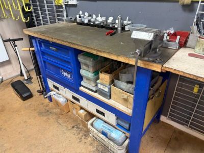 a workbench with tools on top of it in a garage